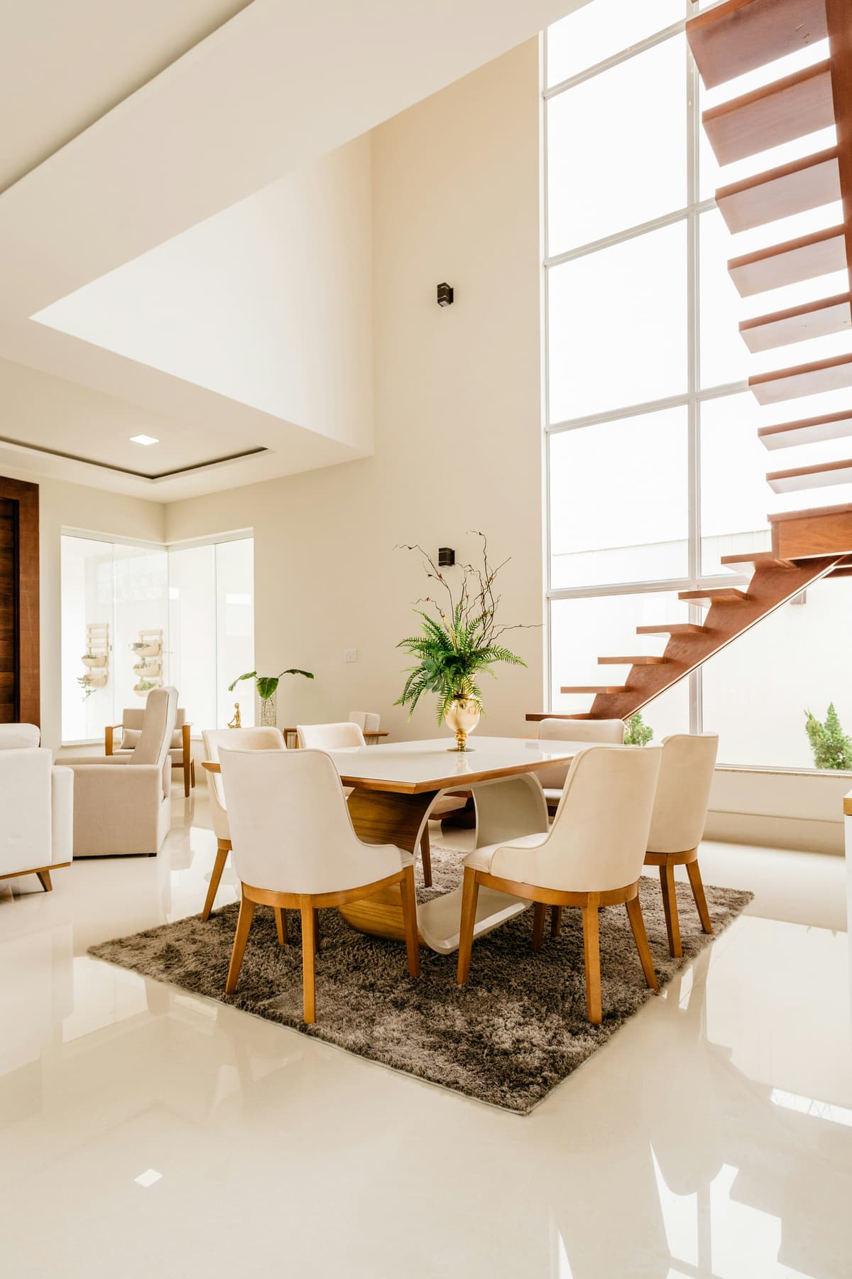 Open timber staircase beside tall, freshly painted white walls